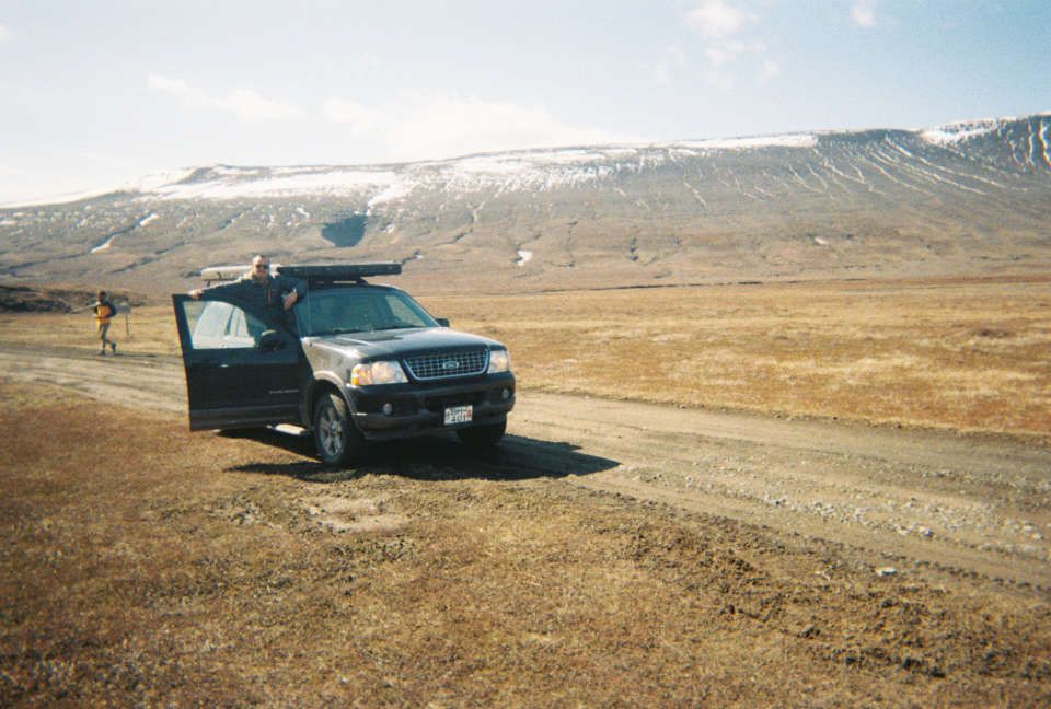 Ford Explorer parked on a dirt road in a glacial valley
