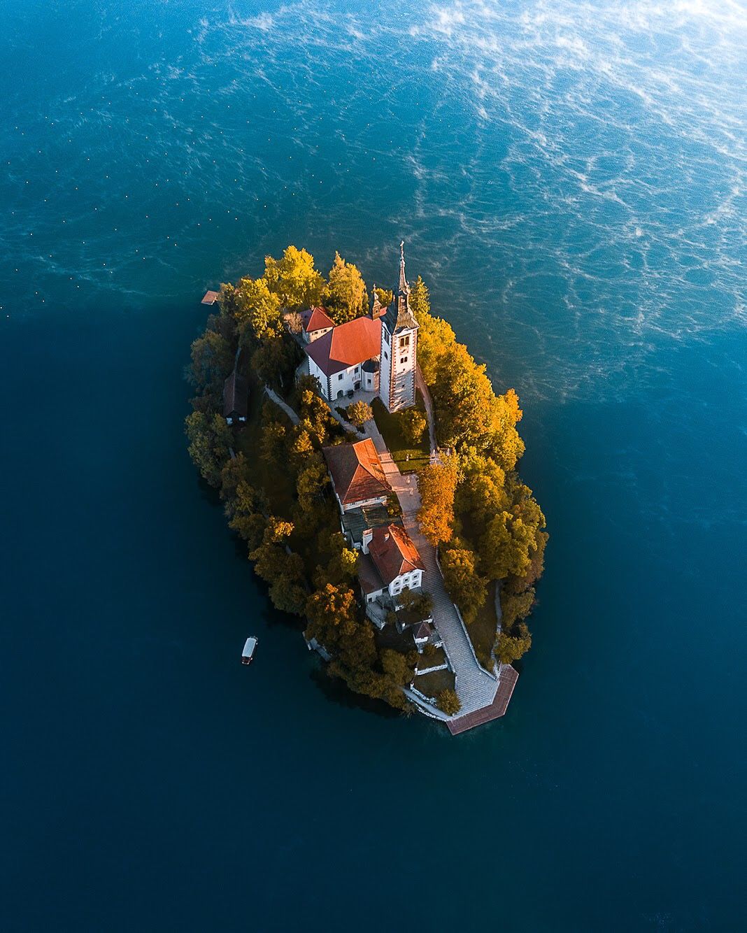 Aerial view of Bled Island's church and buildings on Lake Bled
